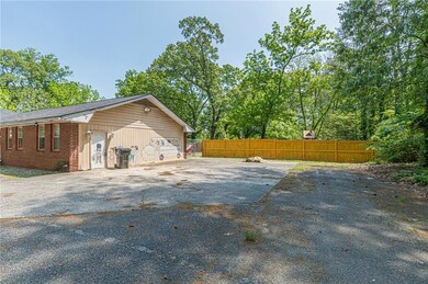 View of side of property with brick siding and fence