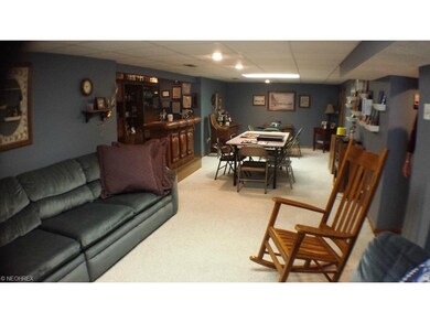 Spacious family room in basement with carpet and b