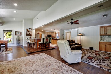Living area featuring visible vents, baseboards, 