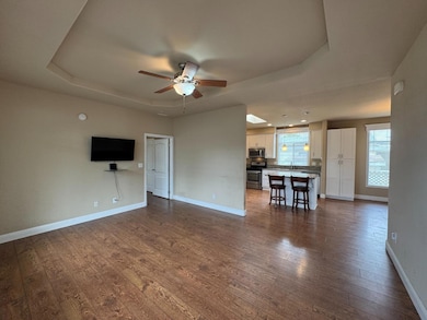 Living room at entrance with coffered ceiling and fan