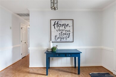 Corridor featuring crown molding and light parquet