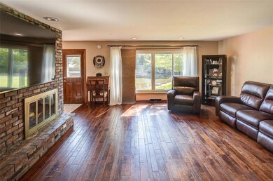 4-panel window with a stellar view of the water & trees with a door going out to the wood deck.