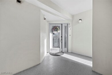 Front door to home in a covered, screened hallway