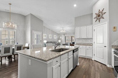 Kitchen featuring decorative light fixtures, dishw