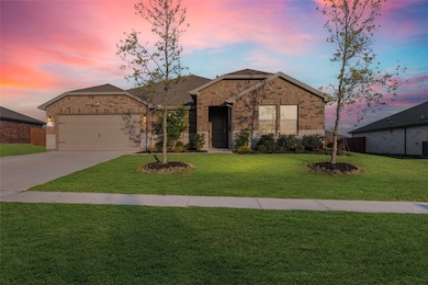 Ranch-style house featuring driveway, brick siding, and a garage
