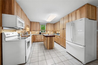 The beautiful kitchen boasts quartz counters, cust