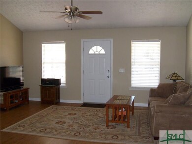 Entering Great Room with Vaulted Ceiling, Wood-Lik