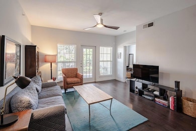 Living area featuring ceiling fan and wood finish