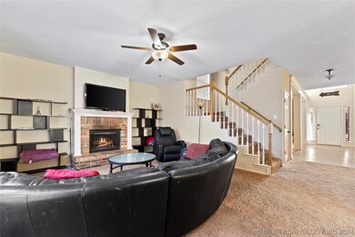 Living room off kitchen, with fireplace.