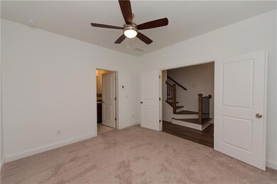 Unfurnished bedroom featuring carpet flooring, baseboards, and ceiling fan