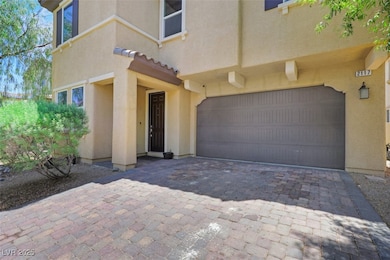 Entrance to property featuring a garage, stucco si