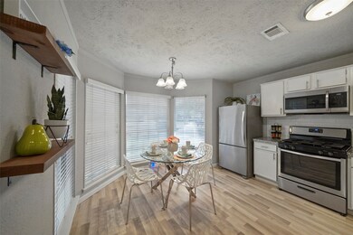 This inviting eat-in kitchen boasts durable laminate flooring, crisp white cabinetry, sleek subway tile backsplash, granite countertops and stainless steel appliances. This spotless kitchen offers both style and functionality with a cozy breakfast nook and a bright and airy vibe making it the ideal space for morning coffee and casual meals.