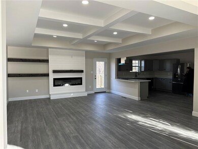 Unfurnished living room with dark wood-type floori
