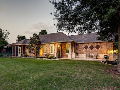View of front facade featuring a yard and a patio 