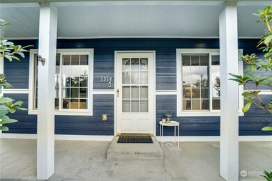 A paved path leads to the covered front porch where you can get an up-close look at the fresh paint job done this spring.