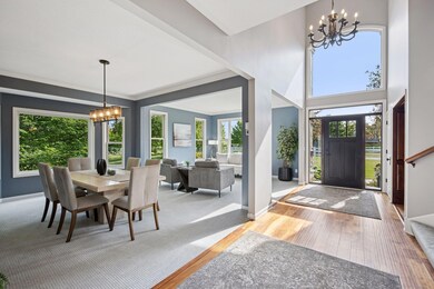 Grand foyer with formal living room & dining area welcome guests.