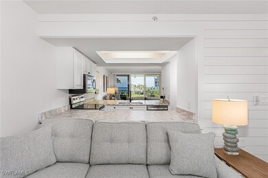 Living room featuring sink and a tray ceiling
