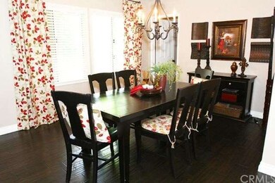 Beautiful dark wood flooring and large family dini