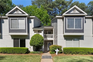 Multi unit property featuring a front lawn and a b