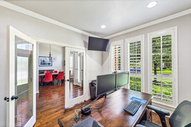 Spacious office with lots of natural light and built-ins for all of your showcase and storage needs.