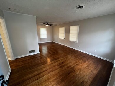 Unfurnished room with dark wood-type flooring, a c