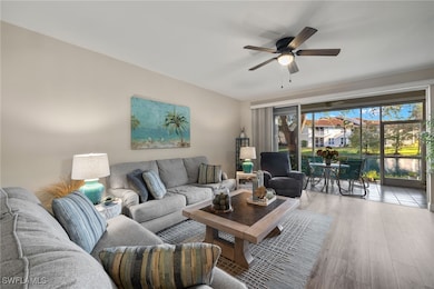 Living room featuring ceiling fan and light hardwo