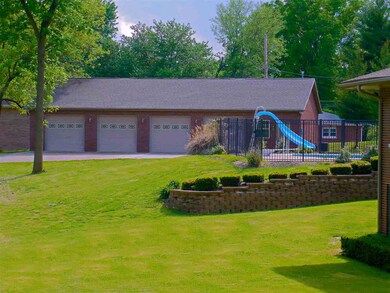 And a detached brick building with 4 car bays that
