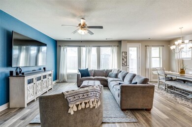Living area featuring baseboards, a textured ceili
