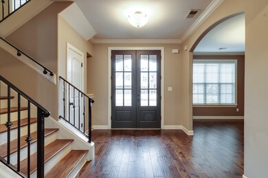 Entryway featuring dark wood-type flooring, orname