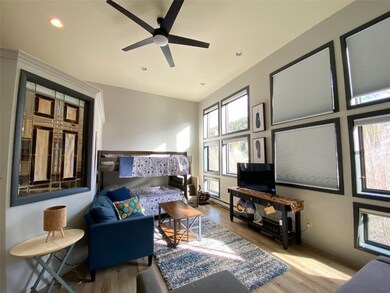Living room with light wood-style flooring, a ceiling fan, and recessed lighting