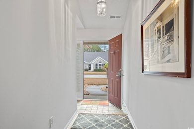 Doorway to outside with baseboards and visible ven