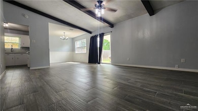 Unfurnished living room with beamed ceiling, dark wood-type flooring, a sink, a chandelier, and ceiling fan