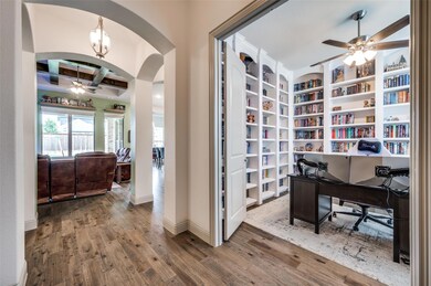 Home office with beamed ceiling, built in shelves,