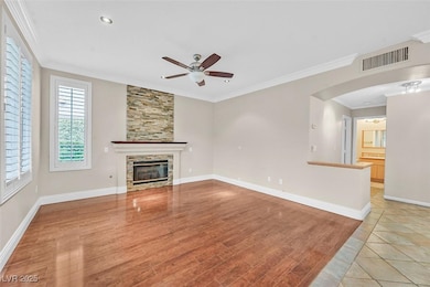 Unfurnished living room featuring ceiling fan, a f
