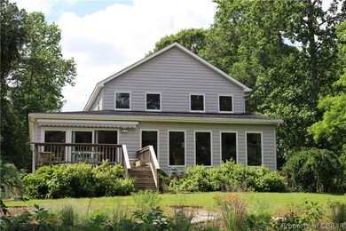 Water side of home with deck and awning