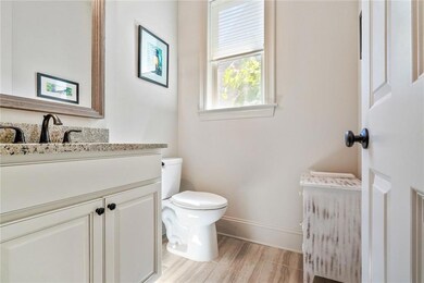 Powder room conveniently located off of dining are