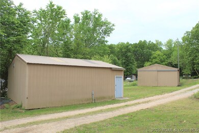 Two metal shop buildings. The closest one has powe