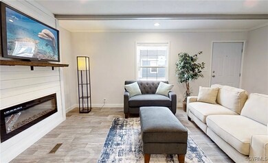 Living room featuring beamed ceiling, a glass cove