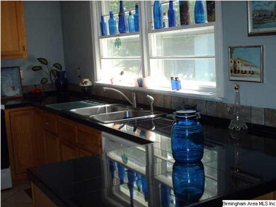 Kitchen sink and windows have view of deck and bac