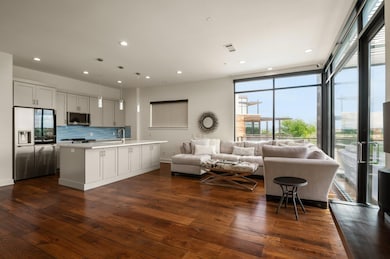 Living area with dark wood-type flooring and rece