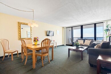Dining space with dark colored carpet, expansive w