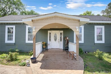 Entrance to property with a porch and a shingled r