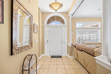 Entrance foyer with baseboards and decorative colu