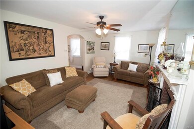 full view of living room with hardwood floors, ple