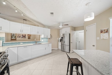 Modern kitchen charm with a view to the living room for entertaining ease.