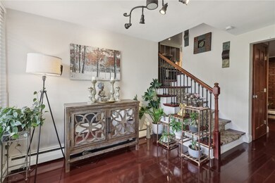 Well lit entryway and the beautiful hardwood floor