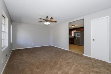Unfurnished room with light carpet and ceiling fan