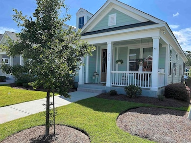 View of front facade with a porch and a front lawn.