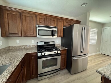 Kitchen featuring stainless steel appliances, ligh