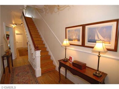 Foyer - Beautiful hardwood floors, a transom window above the front door & a beautiful staircase.